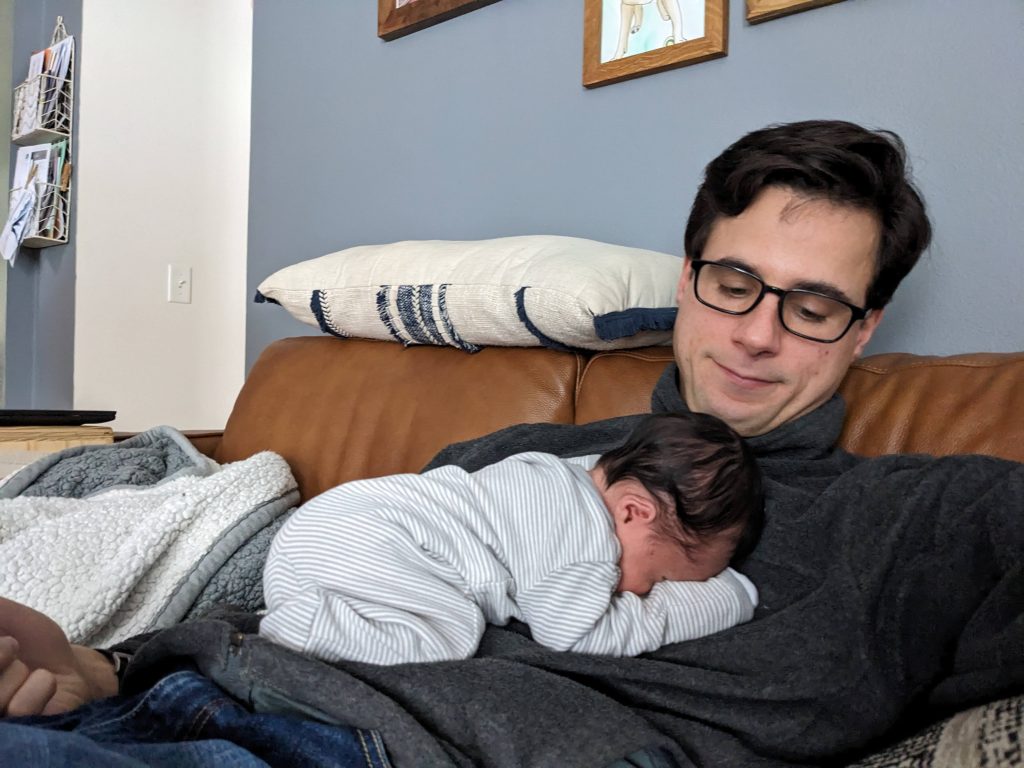 Baby napping face down on her dad